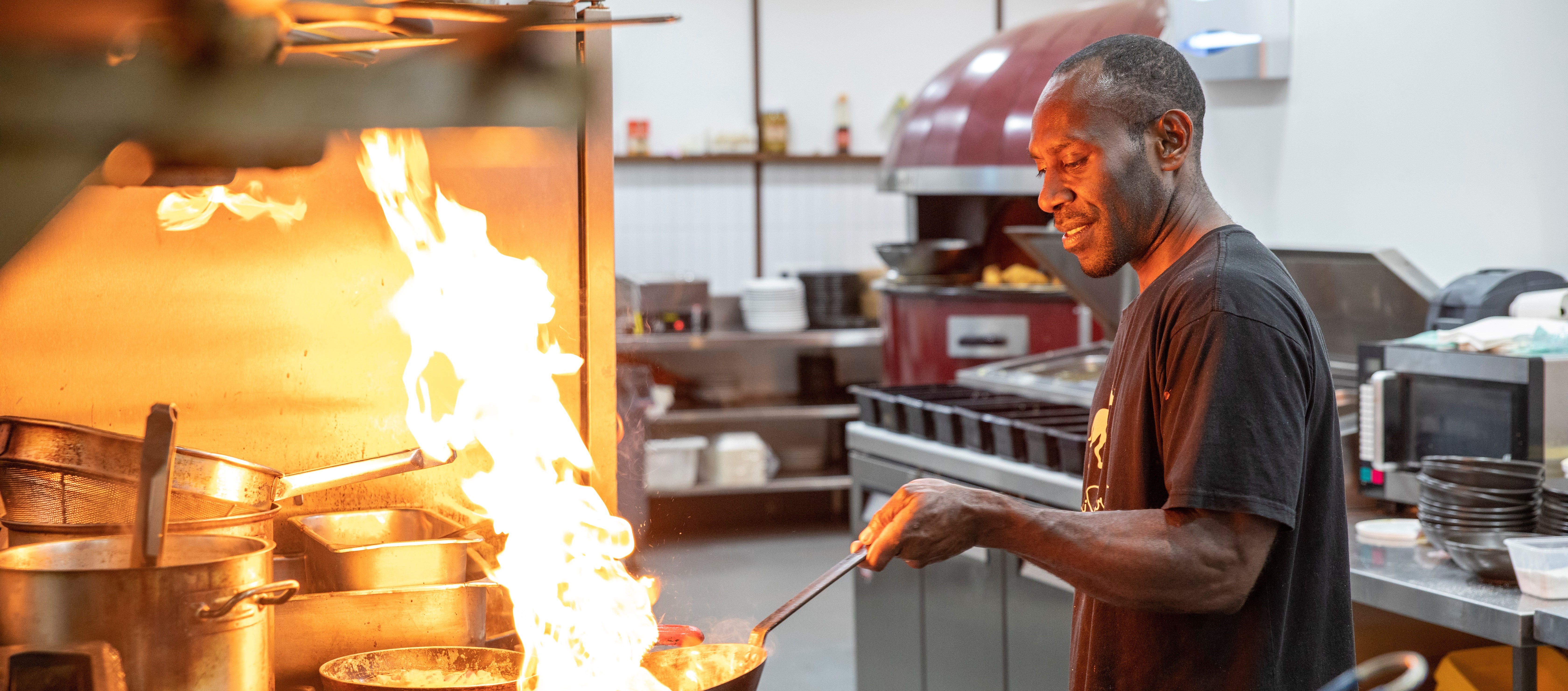 A man cooking in a commercial kitchen 