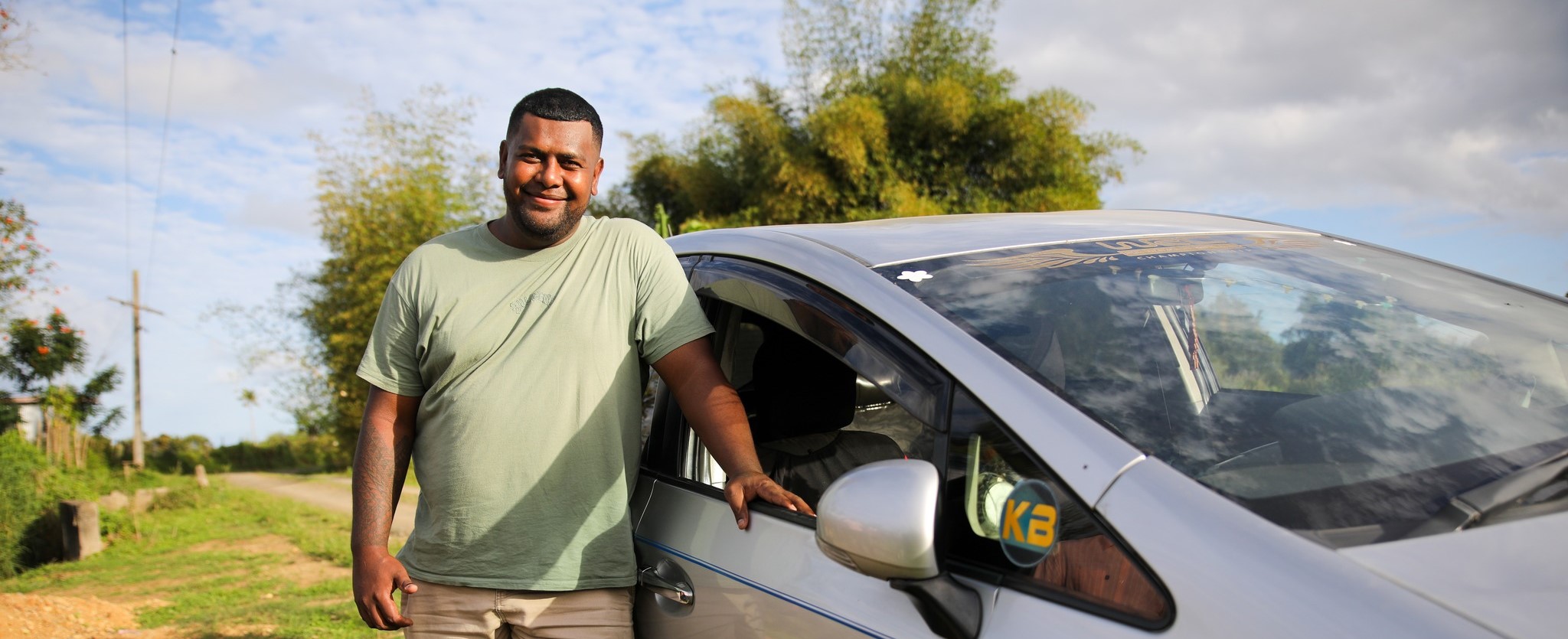 Image of PALM scheme worker standing infront of car