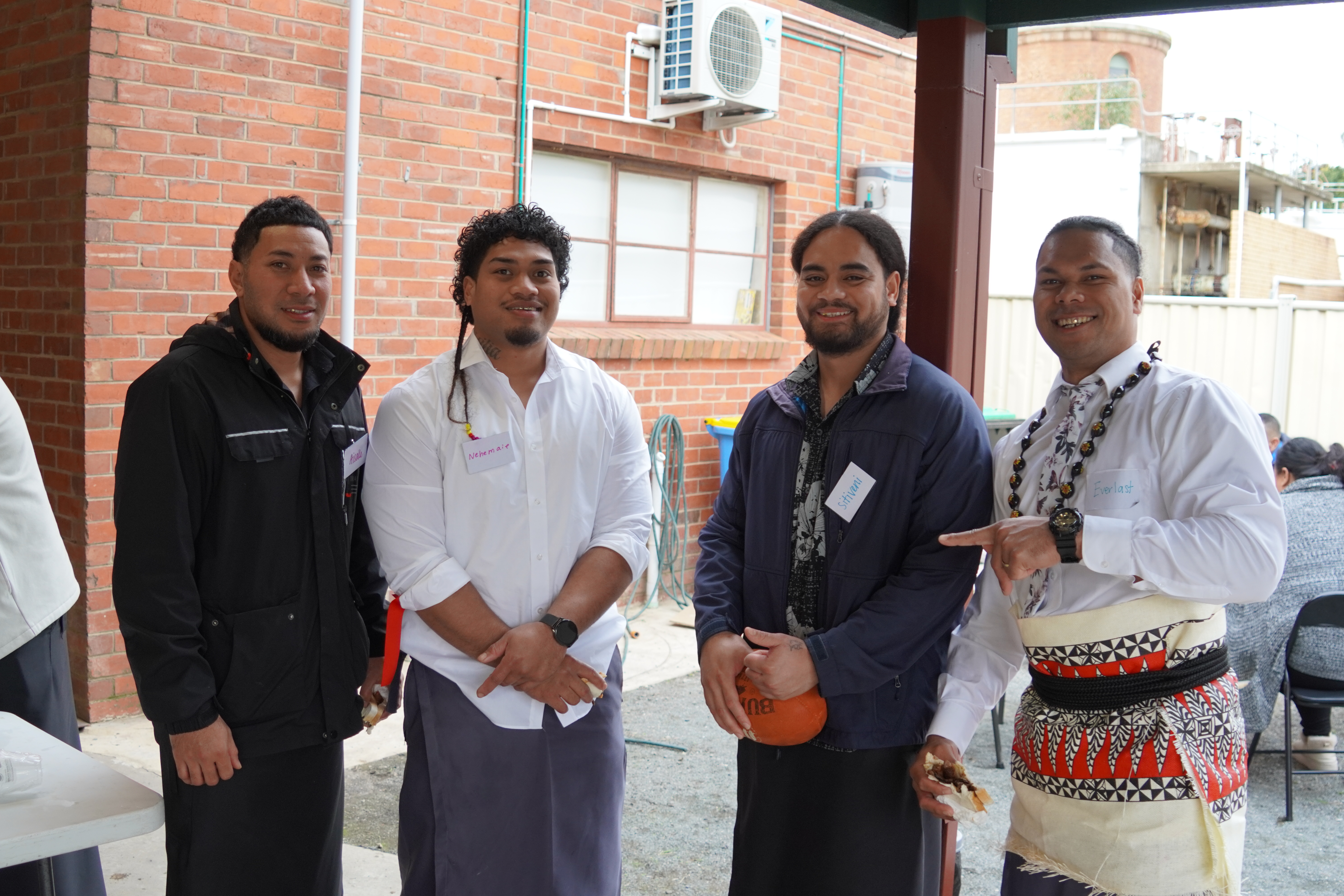Four men smiling