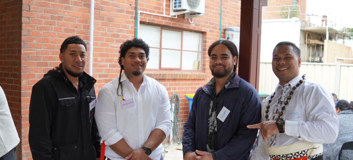 Four men smiling