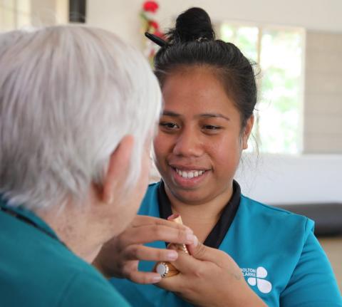 A Kiribati aged care worker with a resident at the Bolton Clarke facility in Longreach