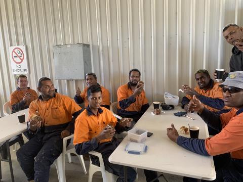 Fijian men hold hot cross buns during Easter celebrations
