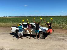 4 Ni-Vanuatu people jump into the air and celebrate by holding up L plates.
