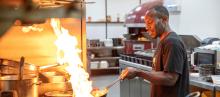 A man cooking in a commercial kitchen 