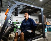 Image of a female PALM scheme worker operating a forklift